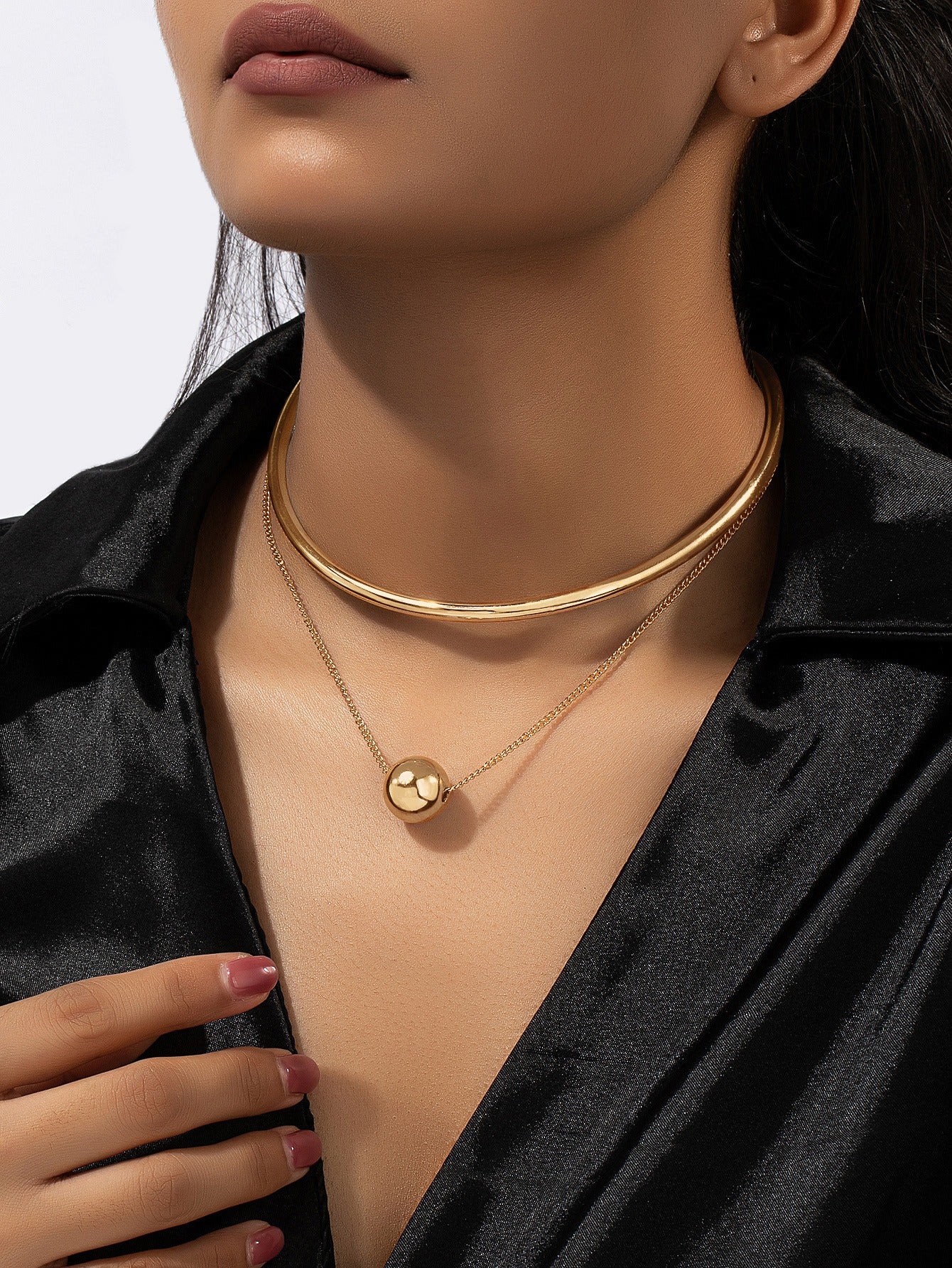 A niche design combination of stacked round ball necklaces and collars